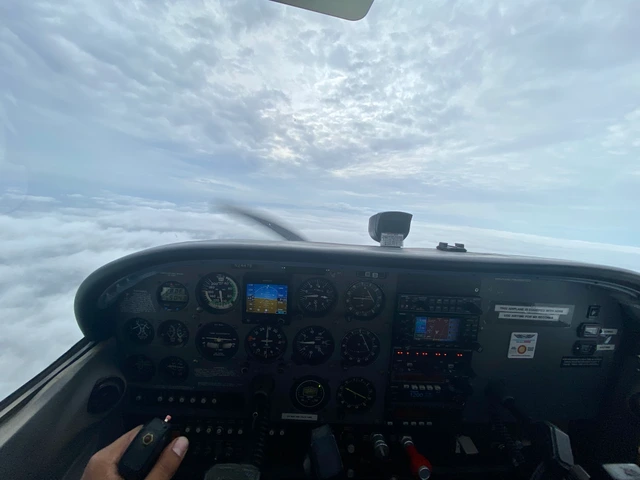 A cockpit view above a cloud layer.